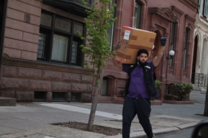 FedEx worker salutes the cancel the rents car caravan, Philadelphia. Liberation Photo. 